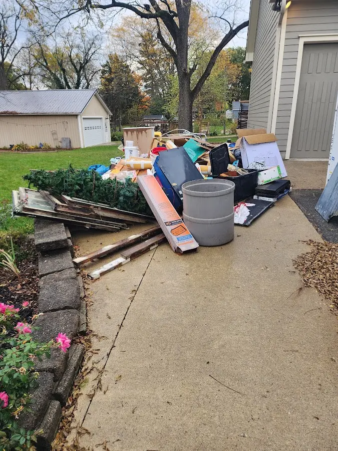 Dumpster being loaded with debris for Commercial Dumpster Rental in Alabaster
